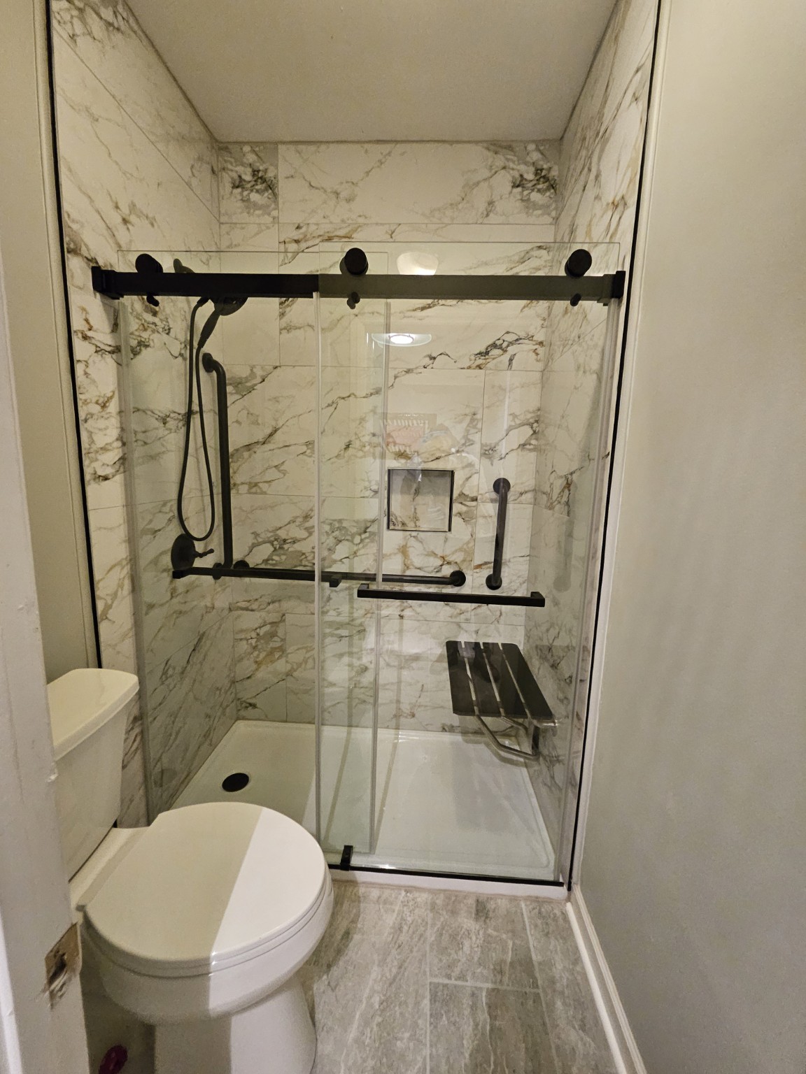 Finished walk-in shower with glass enclosure