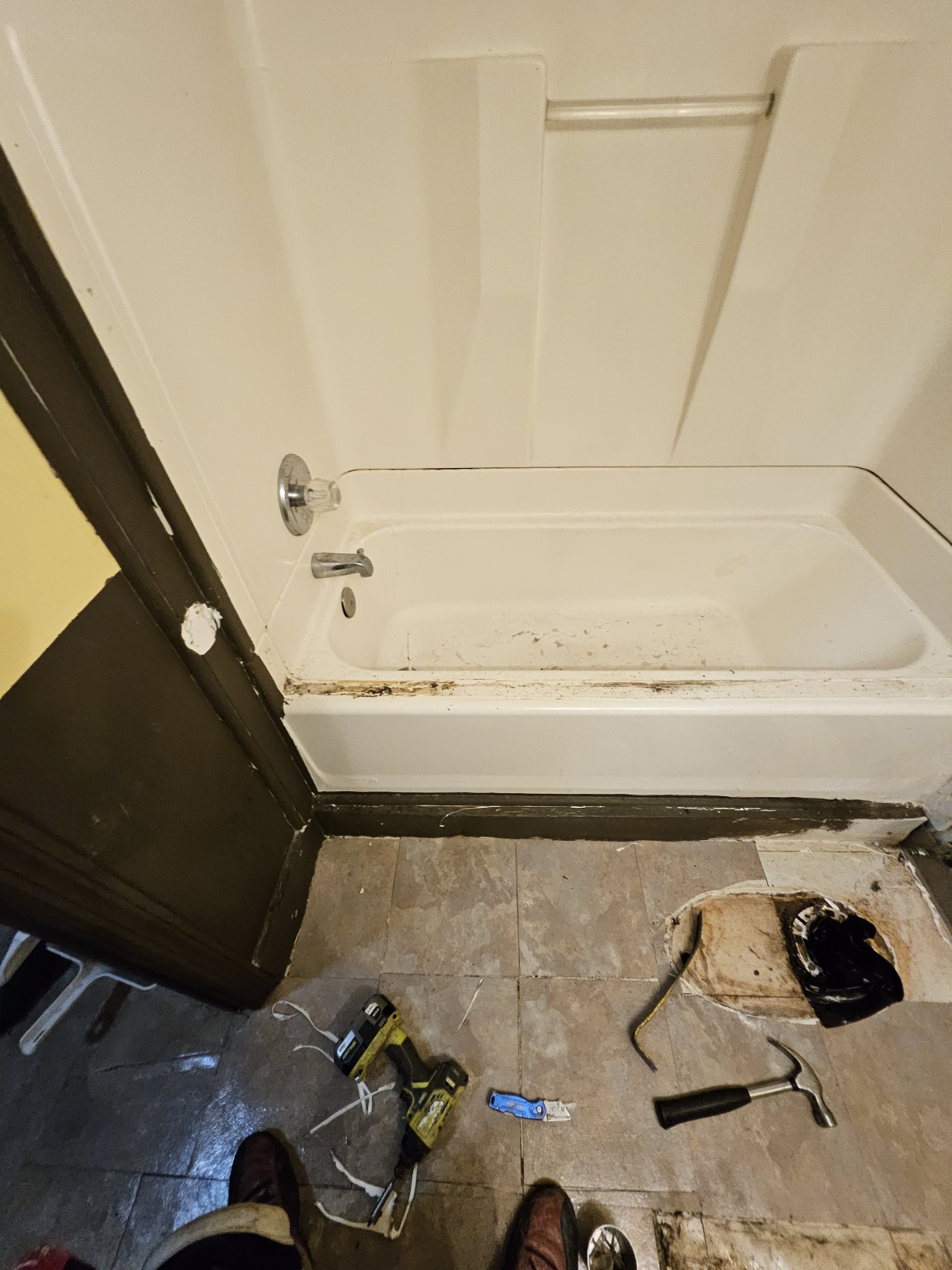Bathroom before renovation, showing the original white bathtub