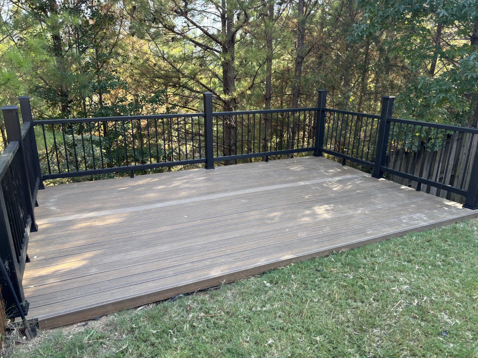 Completed deck with new boards and dark railings