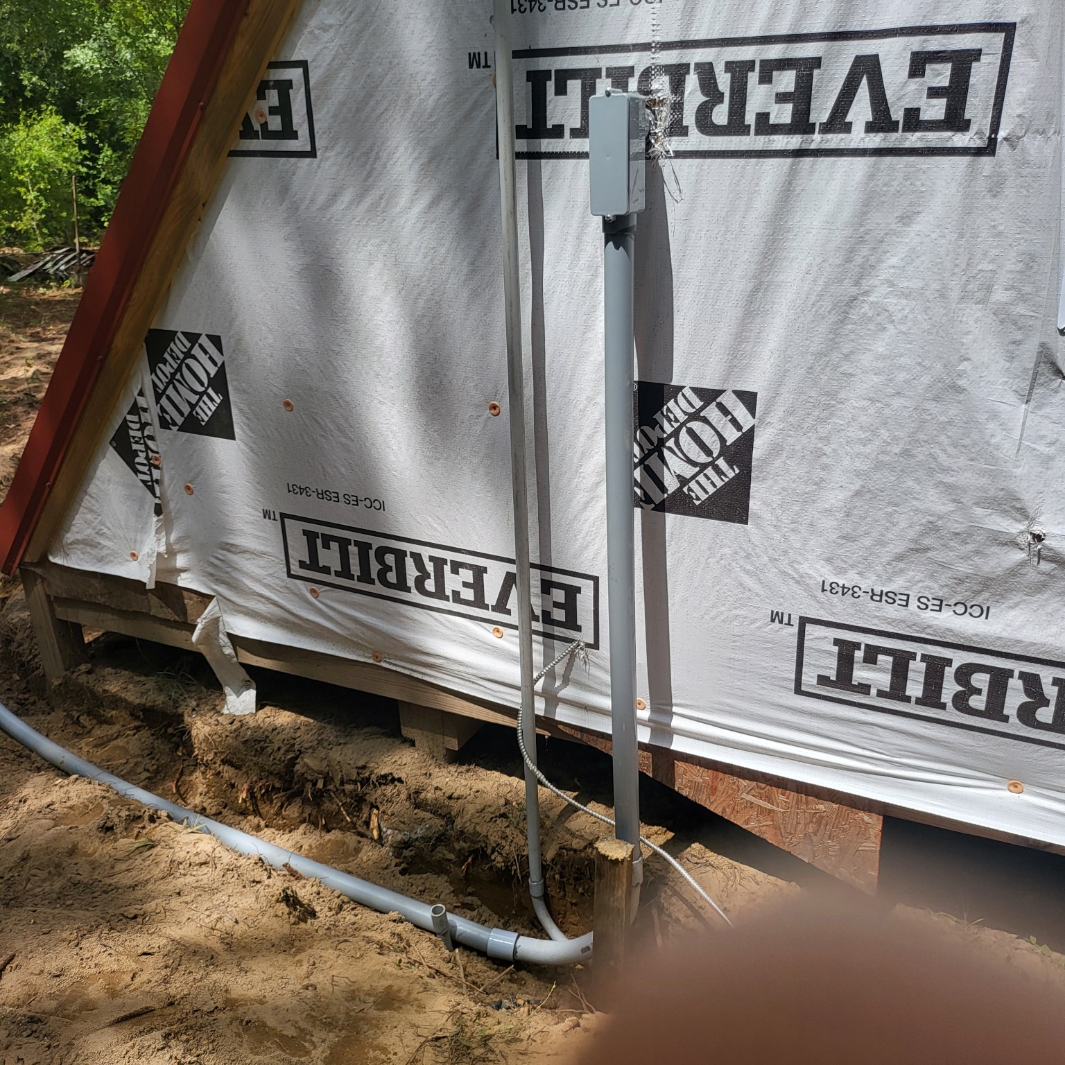 Exterior conduit and electrical box at a building under construction