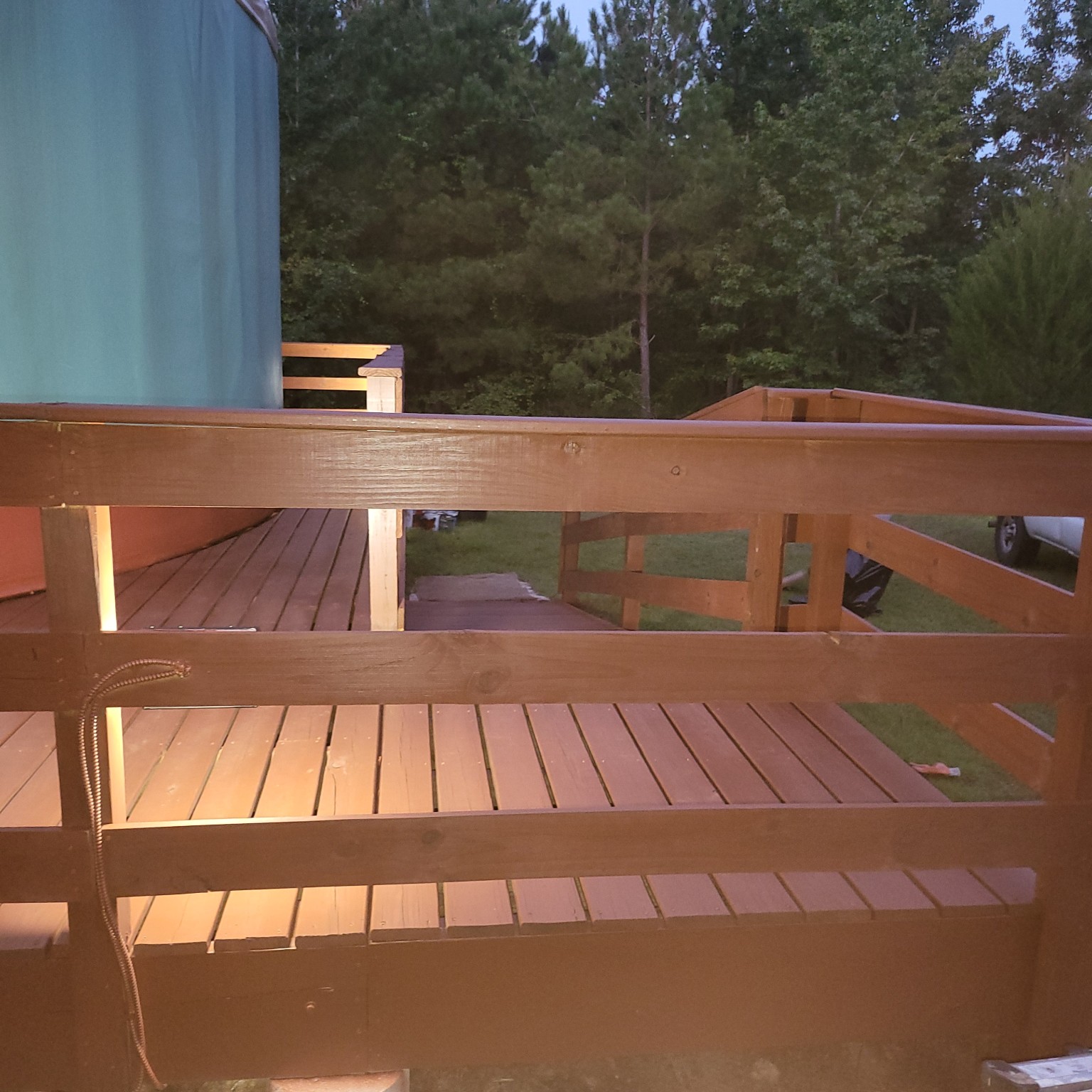 Wooden deck railing beside the yurt